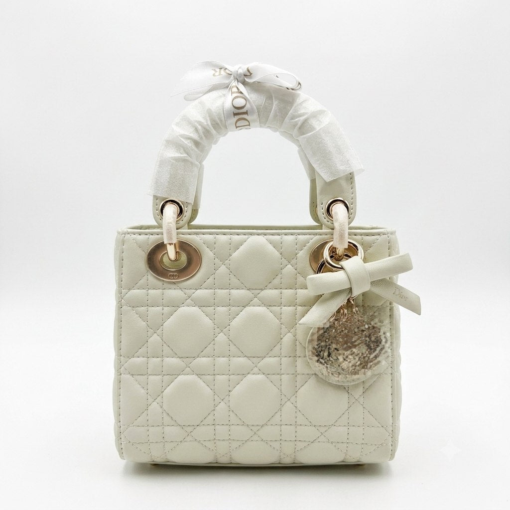 Elegant Leather Bag with Metal Charms and Bow Detail