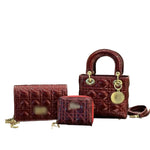 Three lined handbags in a glossy burgundy color