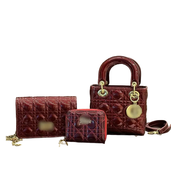 Three lined handbags in a glossy burgundy color
