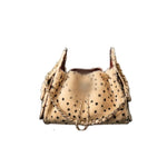 A beige fur drawstring handbag with black spots