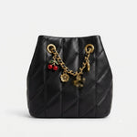 Small bucket bag adorned with attractive accessories