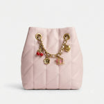 Small bucket bag adorned with attractive accessories