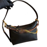 leather shoulder bag with a gold chain strap