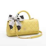 leather handbag with a top handle, gold-tone chain strap