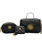 Three black quilted handbags