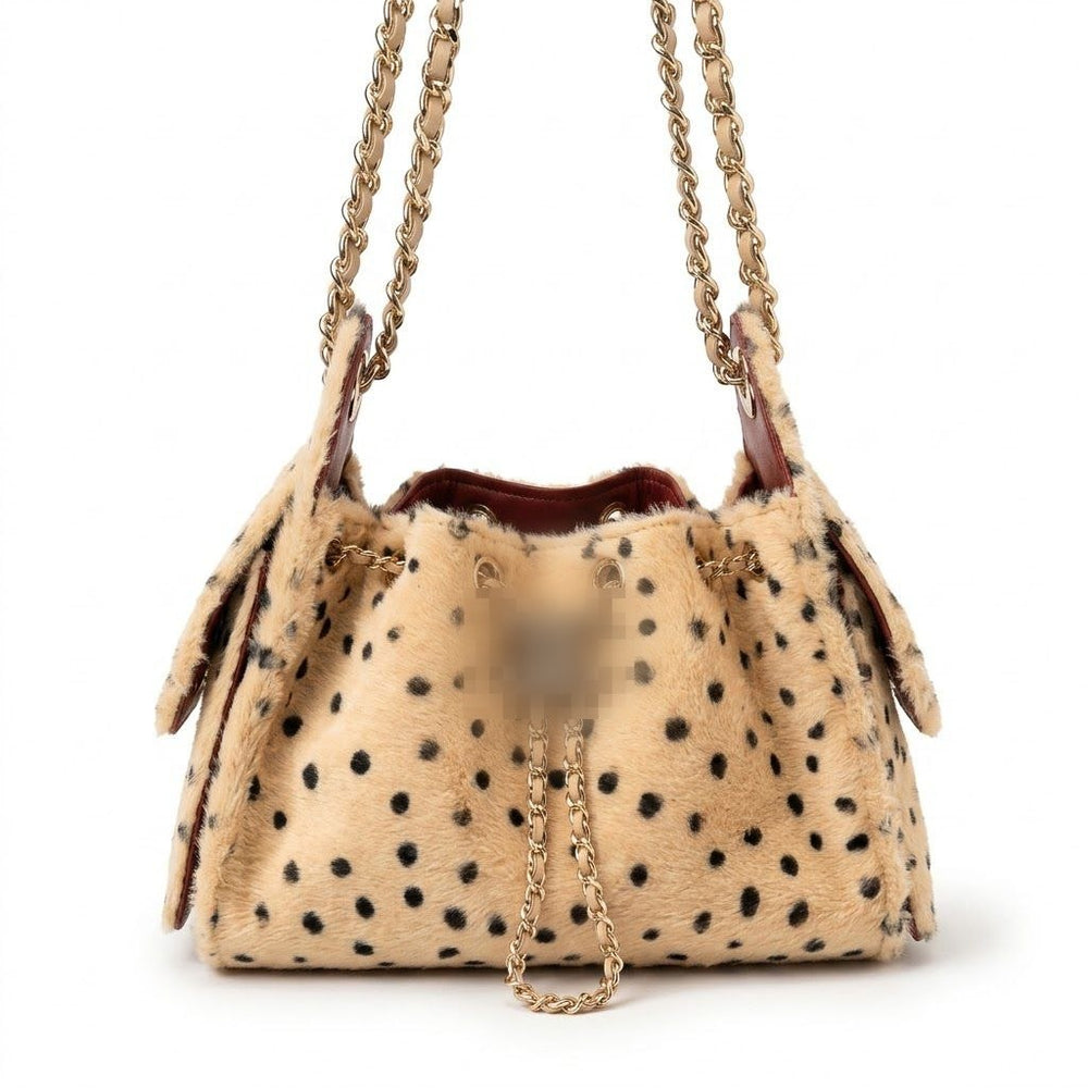 A beige fur drawstring handbag with black spots