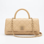 leather handbag with a top handle, gold-tone chain strap