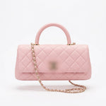 leather handbag with a top handle, gold-tone chain strap