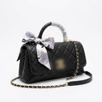 leather handbag with a top handle, gold-tone chain strap
