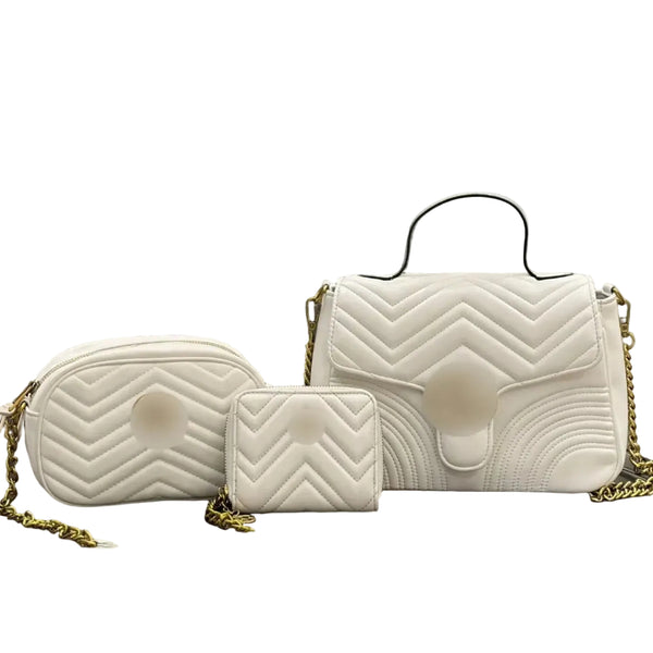 A white quilted handbag set with matching pouches